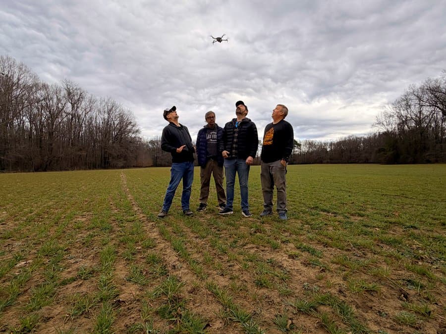 Megayacht standing in a field, watching a drone overhead